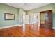 Open bedroom with wood floors, ensuite bathroom, and traditional details at 6 Halsey St, Charleston, SC 29401