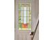 Stunning art deco stained glass window with yellow, green, and amber panes at 6 Halsey St, Charleston, SC 29401