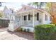 Quaint single-story home featuring a welcoming front porch and neat landscaping at 721 Royall Ave, Mount Pleasant, SC 29464