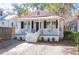 Charming single-story home with a cozy front porch and a well-maintained, landscaped yard at 721 Royall Ave, Mount Pleasant, SC 29464