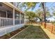 Spacious backyard showcasing a well-manicured lawn, defined planting beds, and classic wooden fence at 74 6Th Ave, Charleston, SC 29403