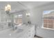 Bright bathroom featuring double sink, large mirror, and a clear glass shower with white tile at 74 6Th Ave, Charleston, SC 29403
