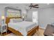 Comfortable bedroom featuring hardwood floors, a ceiling fan, and a window with natural light at 74 6Th Ave, Charleston, SC 29403