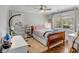 Relaxing bedroom featuring hardwood floors, a ceiling fan, and a large window with natural light at 74 6Th Ave, Charleston, SC 29403