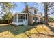 Charming two-story home with brick, a screened porch, manicured landscaping, and mature trees at 74 6Th Ave, Charleston, SC 29403