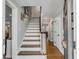 Inviting foyer featuring hardwood floors, white trim, and a staircase leading to the upper level at 74 6Th Ave, Charleston, SC 29403