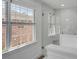 Bright shower with large glass enclosure featuring white tile and bright window at 74 6Th Ave, Charleston, SC 29403