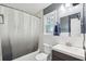 A bathroom features a shower with curtain, toilet, and a sink with a dark wood cabinet at 840 Burger St, Charleston, SC 29407