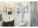 A bright bathroom with a glass door shower, white wainscoting, and a modern vanity at 840 Burger St, Charleston, SC 29407