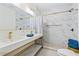 Modern bathroom with double vanity, elegant fixtures, and tiled walk-in shower at 8834 Palmetto Rd, Edisto Island, SC 29438