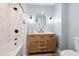 Stylish bathroom featuring white-tiled walls, and a wood vanity with a white countertop at 8834 Palmetto Rd, Edisto Island, SC 29438