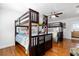 Spacious bedroom showcases two sets of bunkbeds and ceiling fan in a bright interior at 8834 Palmetto Rd, Edisto Island, SC 29438