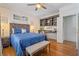 Relaxing bedroom with wood floors, built-in shelving, and coastal decor at 8834 Palmetto Rd, Edisto Island, SC 29438
