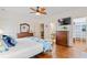 Comfortable bedroom with wood floors, dresser, and TV at 8834 Palmetto Rd, Edisto Island, SC 29438