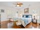 Bright bedroom with hardwood floors, fan, and ample natural light at 8834 Palmetto Rd, Edisto Island, SC 29438
