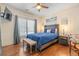 Bright bedroom featuring a rustic wood headboard, and a luxurious blue quilt at 8834 Palmetto Rd, Edisto Island, SC 29438