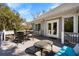 Outdoor deck with dining table and cushioned seating offering a view of the surrounding trees at 8834 Palmetto Rd, Edisto Island, SC 29438