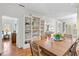 Dining room with custom built-in shelving, and hardwood floors at 8834 Palmetto Rd, Edisto Island, SC 29438