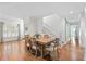 Open dining room with wood floors, bright lighting, and access to the staircase at 8834 Palmetto Rd, Edisto Island, SC 29438
