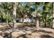 Charming home with a gray exterior nestled among trees and featuring a front porch at 8834 Palmetto Rd, Edisto Island, SC 29438
