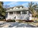 Charming coastal home with a spacious front porch and lush landscaping at 8834 Palmetto Rd, Edisto Island, SC 29438