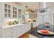Elegant kitchen with white cabinets, stainless steel appliances, granite countertops, and hardwood floors at 8834 Palmetto Rd, Edisto Island, SC 29438