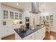 Bright kitchen featuring white cabinets, stainless steel appliances, a black granite island, and breakfast nook at 8834 Palmetto Rd, Edisto Island, SC 29438