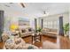 Cozy living room features hardwood floors, wainscoting, stylish furnishings, and decor at 8834 Palmetto Rd, Edisto Island, SC 29438