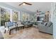 Bright sunroom with tile floors, comfortable seating, built-in bookshelves, and abundant natural light at 8834 Palmetto Rd, Edisto Island, SC 29438