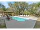 Backyard pool with a spacious concrete patio, lounge chairs, and covered dining area perfect for outdoor entertaining at 8834 Palmetto Rd, Edisto Island, SC 29438