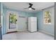 Room with a fridge, door to the outside, and a window, offering functionality and natural light at 8834 Palmetto Rd, Edisto Island, SC 29438