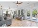 Inviting sun room features tile floors, casual seating, and access to the outdoors at 8834 Palmetto Rd, Edisto Island, SC 29438
