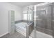 Bright bathroom with shower, tub, cabinet, and window for a relaxing atmosphere at 9620 Corby Ct, Summerville, SC 29485