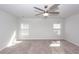 Spacious bedroom featuring plush carpeting, a modern ceiling fan, and ample natural light from two windows at 9620 Corby Ct, Summerville, SC 29485