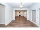 Dining room with hardwood floors and view into the living room featuring a white fireplace at 9620 Corby Ct, Summerville, SC 29485
