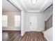 Bright foyer featuring wood-look floors, a staircase, and an entrance to the living room at 9620 Corby Ct, Summerville, SC 29485