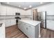 Modern kitchen featuring white cabinets, stainless steel appliances, and a large island with granite countertop at 9620 Corby Ct, Summerville, SC 29485