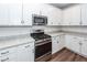 Modern kitchen featuring white cabinets, granite countertops, stainless steel appliances, and subway tile backsplash at 9620 Corby Ct, Summerville, SC 29485