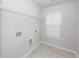 Laundry room with shelving, window, and tile flooring at 9620 Corby Ct, Summerville, SC 29485