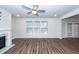 Bright living room features a fireplace, ceiling fan, and windows at 9620 Corby Ct, Summerville, SC 29485