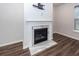 Living room with a white fireplace and hearth and a mounted TV at 9620 Corby Ct, Summerville, SC 29485