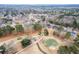 Aerial view of a neighborhood and golf course surrounded by lush trees and houses at 1006 Retreat Ave, Moncks Corner, SC 29461