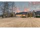 Spacious backyard featuring a brick home with a covered porch and ample green space at 1006 Retreat Ave, Moncks Corner, SC 29461