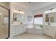 Spacious bathroom with a walk-in shower, dual vanities, and a soaking tub at 1006 Retreat Ave, Moncks Corner, SC 29461