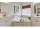 Bright bathroom with a soaking tub, dual vanities, and a large window, offering a serene atmosphere at 1006 Retreat Ave, Moncks Corner, SC 29461