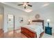 Comfortable bedroom featuring a wooden bed frame, tray ceilings, and ensuite bathroom access at 1006 Retreat Ave, Moncks Corner, SC 29461