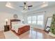 Inviting bedroom with a tray ceiling, a ceiling fan, and large windows for natural light at 1006 Retreat Ave, Moncks Corner, SC 29461