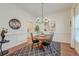 Bright dining room featuring wood floors, wainscoting, stylish lighting, and classic decor at 1006 Retreat Ave, Moncks Corner, SC 29461