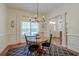 Elegant dining room with hardwood floors, modern chandelier, and large window for natural light at 1006 Retreat Ave, Moncks Corner, SC 29461