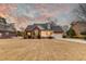 Brick home with a two-car garage, a front porch, and manicured front lawn at 1006 Retreat Ave, Moncks Corner, SC 29461